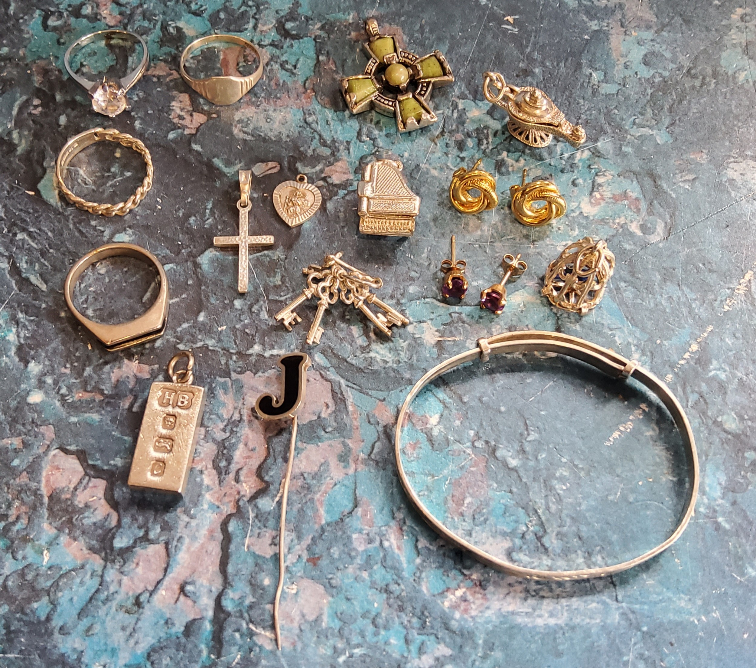 A silver ingot pendant;   charms;  silver bracelet;  rings;  etc