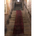 A large 19th century Persian Hamadan runner, hand knotted, from the attic of the Hassop Hall Estate,