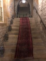 A large 19th century Persian Hamadan runner, hand knotted, from the attic of the Hassop Hall Estate,