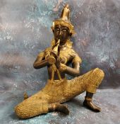 Thai School, 20th century, a gilt metal and bronze Thepphanom Buddha, playing a pipe, 43cm high