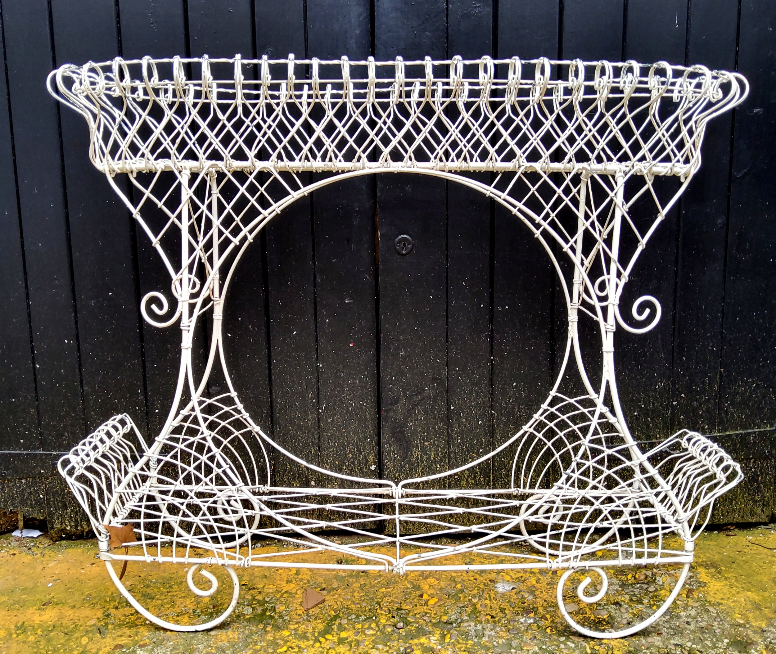 An ornate 20th century metal plant stand, painted white