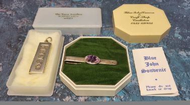 A silver and Blue & John tie slide in original box 7.39g gross; a silver ingot, Pobjoy Mint Ltd.