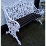 A Coalbrookdale style rustic leaf scroll pattern garden bench, painted white, slatted wood seats