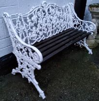 A Coalbrookdale style rustic leaf scroll pattern garden bench, painted white, slatted wood seats