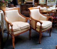A pair of Louis XVI style side chairs, scroll backs, arms and legs, upholstered in cream damask,