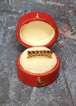 A continental 14ct gold ring claw set with seven ruby cabochons piecered work to shank, stamped 14k,