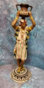 A 20th century cold painted bronze figure, of a Nubian, carrying an urn on his head, 36.5cm high