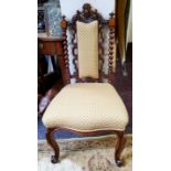 A Victorian walnut nursing chair, leafy carved cresting, upholstered splat, flanked by turned