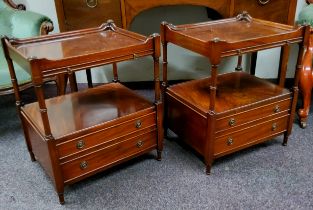 A pair of reproduction mahogany bedside cabinets, the dished top raised by turned supports with