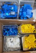 Lego - A Selection of coloured bricks, separated yellow, white and blue.