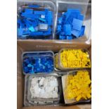 Lego - A Selection of coloured bricks, separated yellow, white and blue.