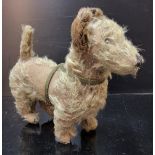 A Late 19th / Early 20th Century plush covered standing dog, scotty or similar, with green leather