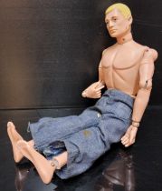 An early Action Man, soft head, flesh coloured rivets, hard hands, c1964 (playworn but intact)
