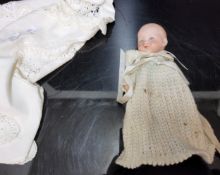 An Armand & Marseille (Germany) bisque head and painted composition baby doll, the bisque head