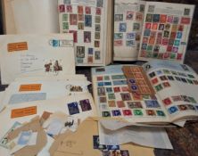 Stamps- a quantity of world postage stamps in 3 junior albums and a large envelope plus an album