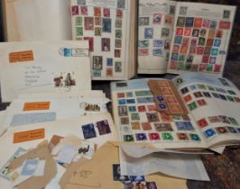 Stamps- a quantity of world postage stamps in 3 junior albums and a large envelope plus an album