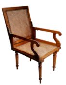 A 19th century bergère campaign library chair,  possibly by J. Ward, 5 & 6 Leicester Square, London,