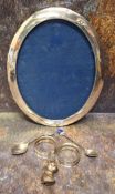 A silver oval photograph frame, 24.5cm high, Birmingham 1916; a pair of Edwardian silver napkin