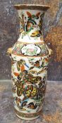 A 19th century Chinese vase, decorated in polychrome with butterflies and insects, gilt mask