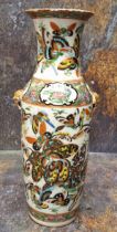 A 19th century Chinese vase, decorated in polychrome with butterflies and insects, gilt mask