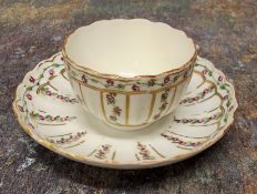 A Bristol tea bowl and saucer,  painted with rose chains in gilt panels, crossed swords & X on
