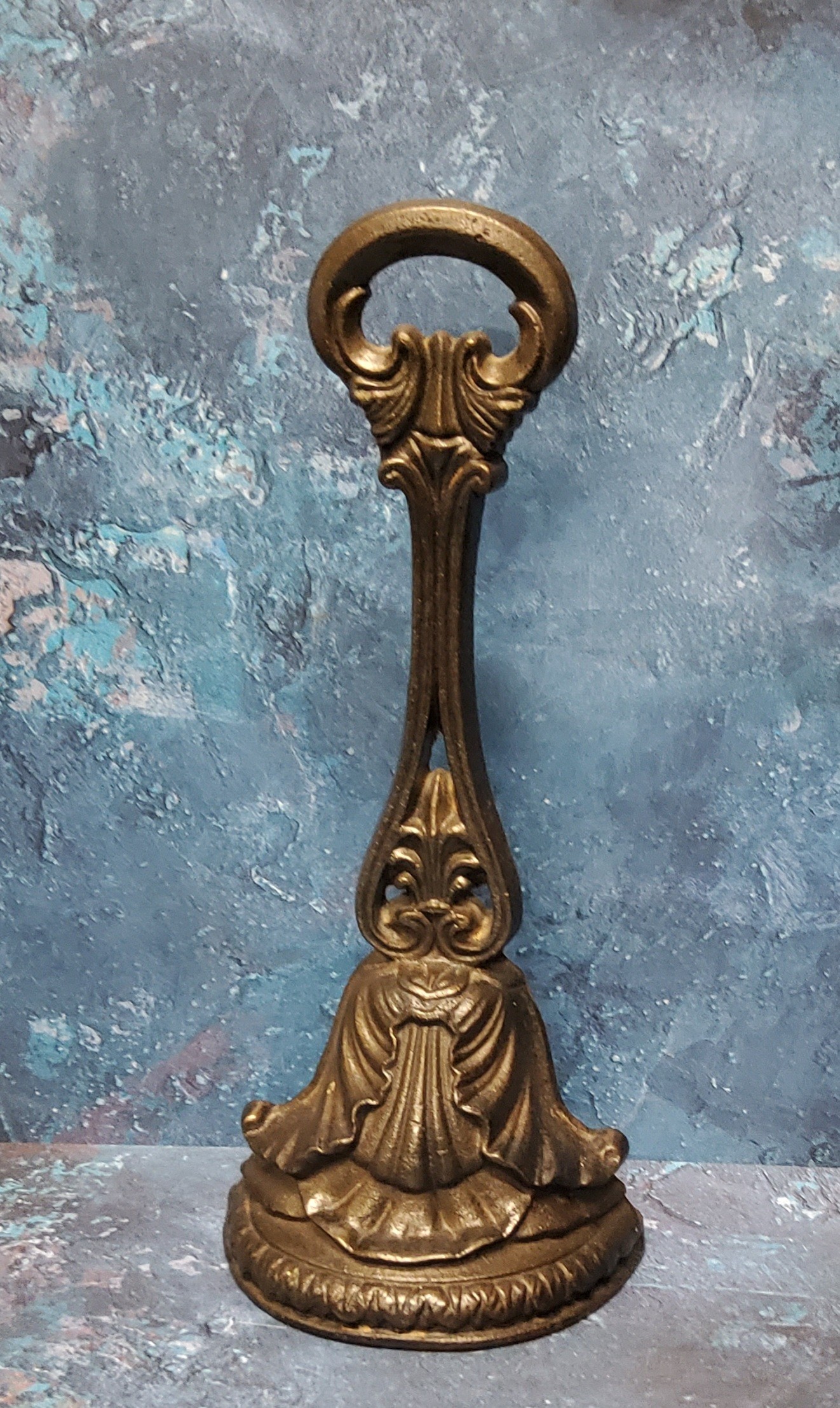 A Victorian cast iron door stop, posted handle, the demi-lune base cast with acanthus, signed