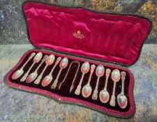 A set of twelve Edwardian silver Fancy teaspoons, sugar bows ensuite, Josiah Williams & Co (George