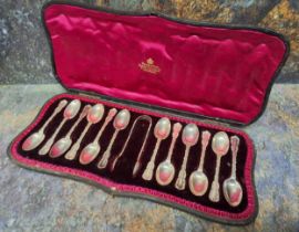 A set of twelve Edwardian silver Fancy teaspoons, sugar bows ensuite, Josiah Williams & Co (George