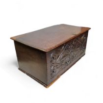 A Charles II oak box, front carved with geometric foliate scrolls, 32cm high, 71cm wide, 39cm deep.