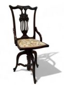 An Edwardian mahogany Chippendale Revival revolving harpists music chair, lyre-back pierced back