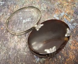 A George III silver coloured metal mounted tortoiseshell oval pocket lens, the oval magnifying glass