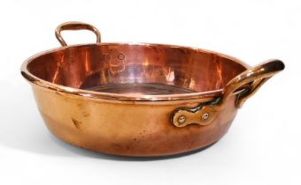 A 19th century copper two handled pan, roll top, 46cm over brass handles