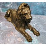 A 19th century cast iron door stop, in the form of lion, reclining, 30cm wide