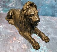 A 19th century cast iron door stop, in the form of lion, reclining, 30cm wide