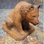 An early 20th century Black Forest bear, seated, canted base, 12cm high, c.1900