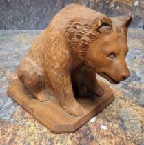 An early 20th century Black Forest bear, seated, canted base, 12cm high, c.1900