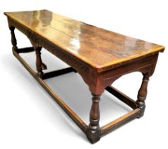 A 17th century William & Mary oak and elm refectory table, the three plank top in well figured