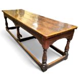A 17th century William & Mary oak and elm refectory table, the three plank top in well figured