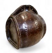 A 17th/18th leather costrel, the open spout flanked by two holes for a strap handle, 21cm high, 20cm