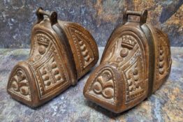 A pair of 19th century continental procession stirrups, carved with roundels and scrolls, 21cm wide