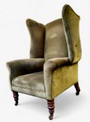 A 19th century Howard & Sons type wingback armchair, turned oak legs, castors, 122cm high, 82cm