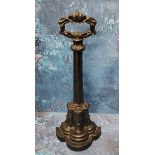 A Victorian cast iron door stop, posted handle, the demi-lune base cast with acanthus, signed