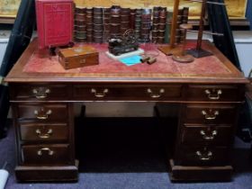 A twin pedestal mahogany desk, tooled leather surface,  three drawers to frieze, drawers to