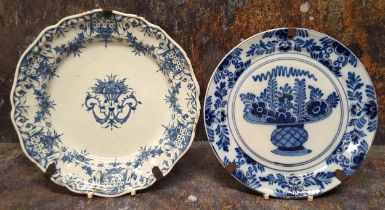 A 19th century tin glazed shaped circular plate, decorated in underglaze blue with stylised foliage,