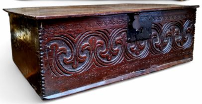 A Charles II English oak bible box / salt box, deep lunette carving and well-patinated one-piece