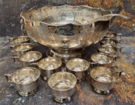 A large silver plated on copper punch bowl, engraved and chased with flowers and acanthus leaves,