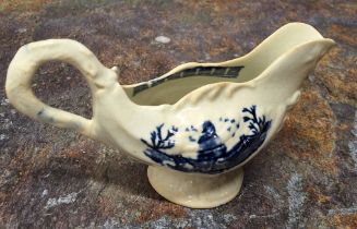 A Liverpool John & Jane Pennington cream jug, moulded in relief with shells, printed in underglaze