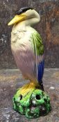 A Bretby flower centrepiece, as a stork, coloured in green, blue and yellow, 20cm high, impressed