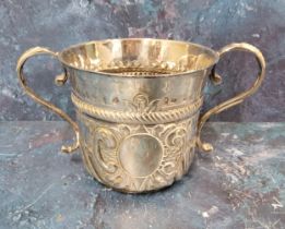 A Queen Anne Britannia standard silver porringer, with fluted and punched vacant cartouche, embossed