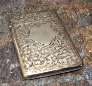 An Edwardian silver rounded rectangular visiting card case, engraved with vacant shield and foliage,